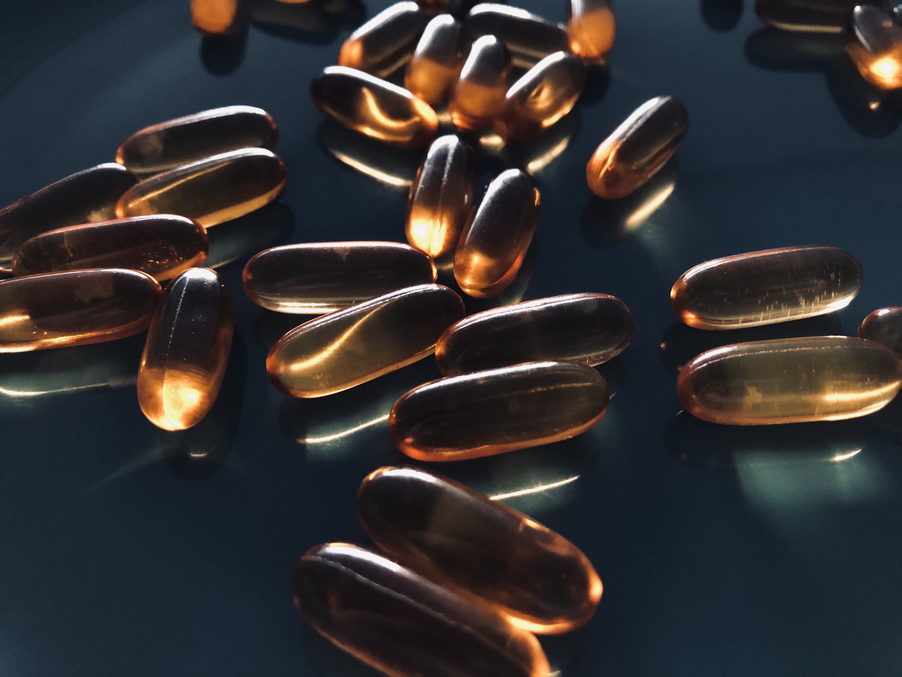 Supplement capsules and natural ingredients representing DHT blocker products