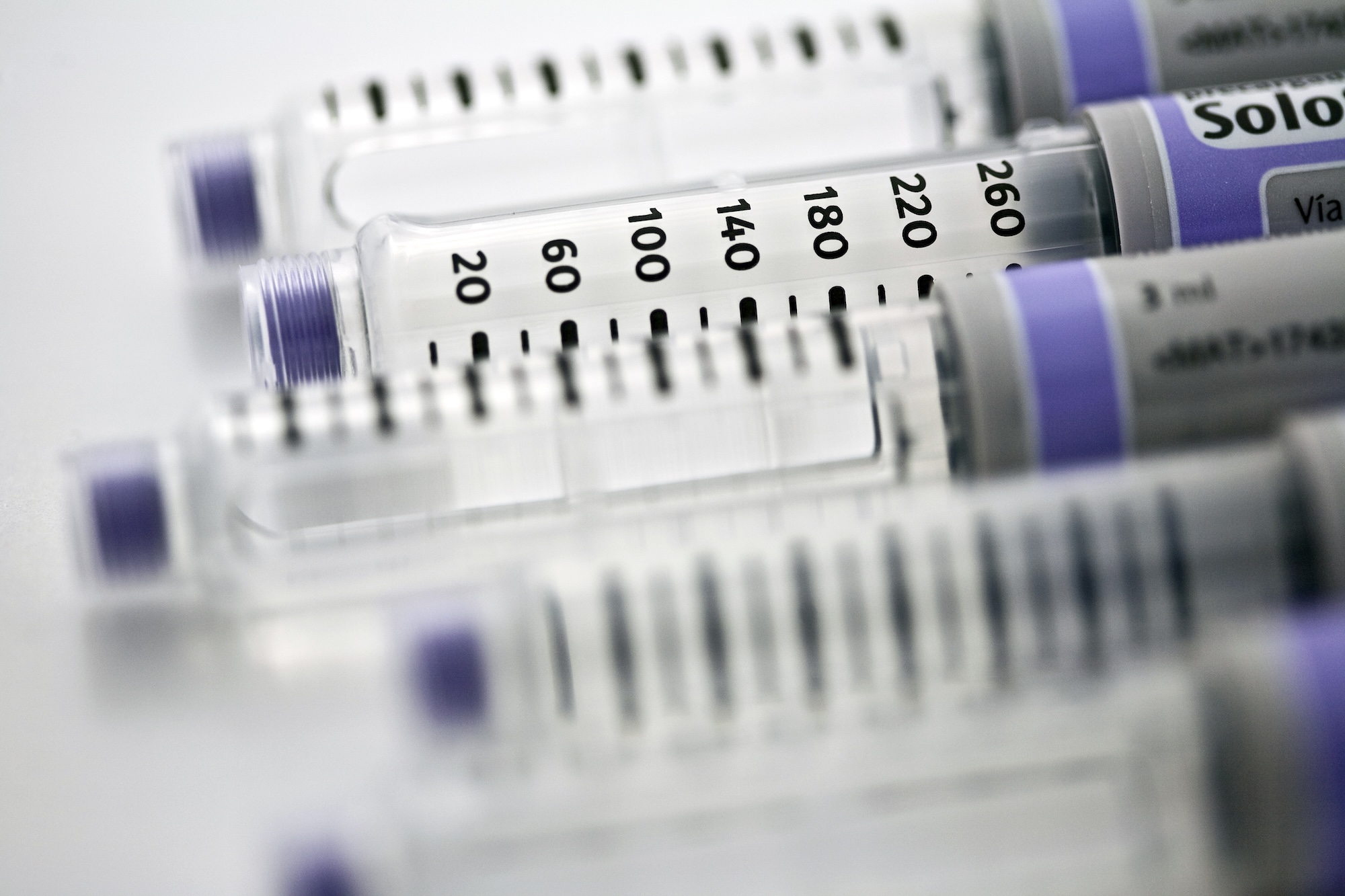 GLP-1 medication injection pen representing semaglutide and tirzepatide