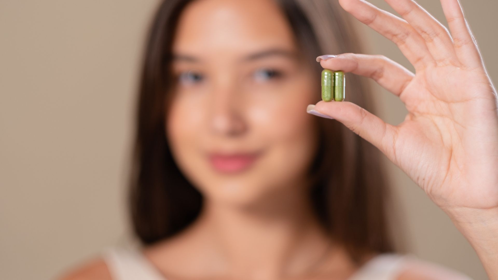 Hair growth supplement capsules and bottles