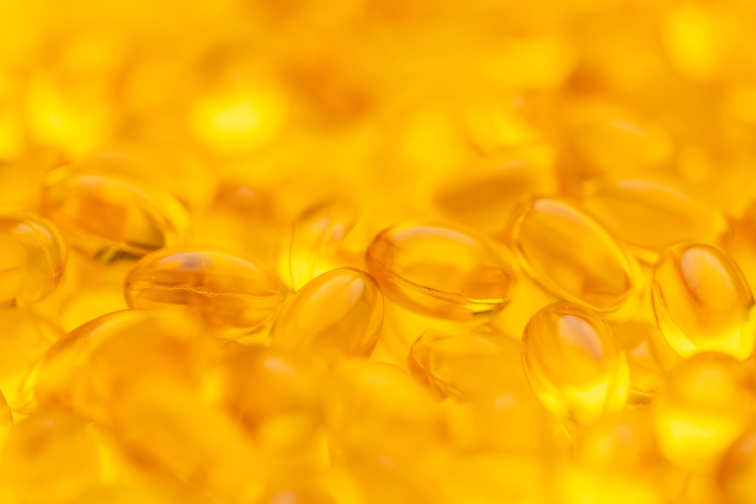 Vitamin D supplement capsules and blood test tube representing hair loss workup